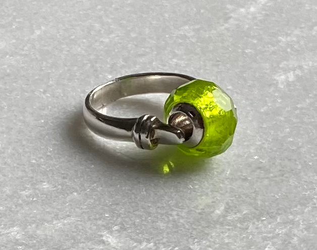 Silver ring with green charm